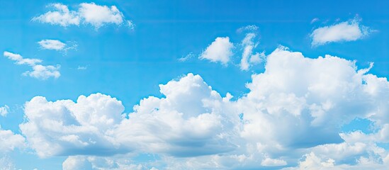 Vibrant azure sky filled with fluffy white clouds spread evenly across the canvas representing a serene summer day ideal for desktop backgrounds
