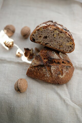 Walnut raisin sourdough bread on a hemp coarse cloth. Sunbeams. Shallow depth of field.