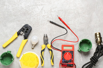 Set of electrician equipment on white grunge background