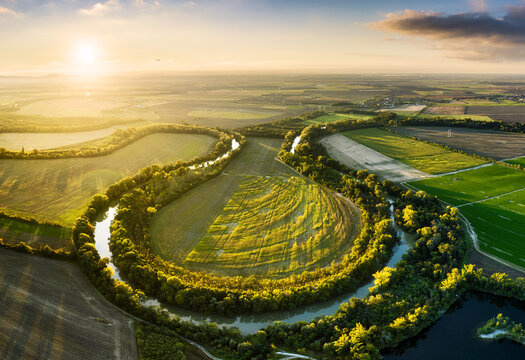 Sunset at Danube river meandering through romantic Slovakia countryside nature landscape Near Senec from drone.