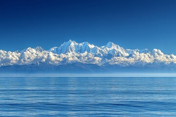 Majestic Snowy Peaks Rising Above Calm Blue Water During Daylight With a Clear Sky and Scattered Clouds in the Background