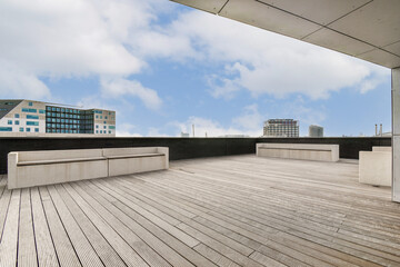 Spacious rooftop terrace featuring wooden flooring and sleek furniture, surrounded by urban...