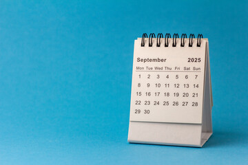 Hello September 2025 Desk calendar for planning on blue background.