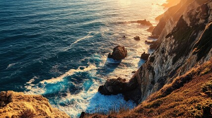 Obraz premium A stunning seaside cliffside at sunset, with the sun casting long shadows over the waves.