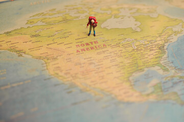 Tiny Figure Exploring North America on Vintage Map Background, Travel concept