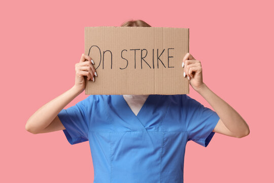 Protesting female doctor holding placard with text ON STRIKE against pink background