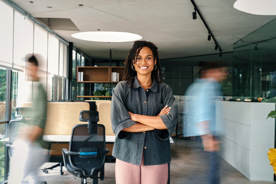 Confidence and happy smiling business woman portrait with blur motion background of his colleague