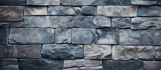 Gray stone tile wall texture with varied shades of gray and blue creating a natural pattern ideal for product display and advertising.