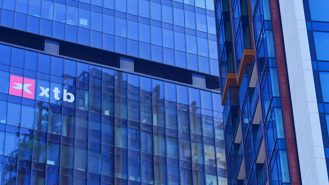 Warsaw, Poland. 22 February 2025. Urban landscape. XTB logo sign on glass wall. Company signboard XTB.