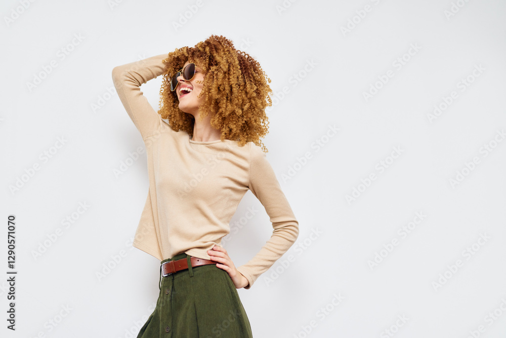 Canvas Prints woman smiling with curly hair, fashionable style, wearing sunglasses, standing confidently against a plain white background, casual outfit emphasizing modern fashion trends and self expression