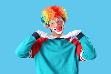 Portrait of happy clown on blue background. April Fool's day celebration