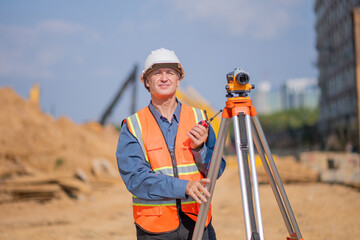 Construction surveyor or engineer working construction site to theodolite mounted  tripod for...