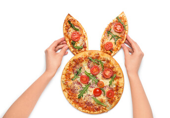 Female hands decorating Easter pizza with bunny ears isolated on white background