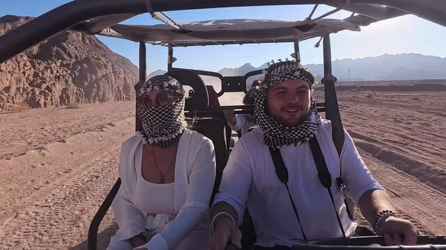 Egyptian activity with off-road vehicles and dust dirt road. Tourists driving on ATV, buggy, quads in the Sahara desert