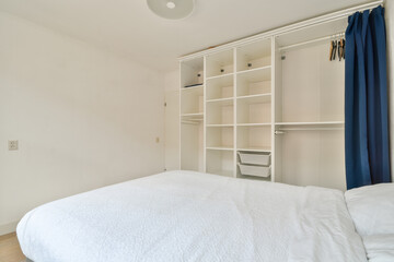 Minimalist bedroom with white bedding and closet