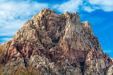 A magnificent mountain dominates the landscape, showcasing its rugged peaks and vibrant colors, creating a breathtaking view that inspires awe and adventure.