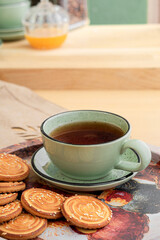 Green mug and saucer on the kitchen table