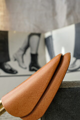 Shoe Shape Holder. Orange color shoe stretcher is on the blurred image of a 1970 fashion magazine...