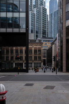 Urban street scene framed by towering skyscrapers and modern architecture, London.