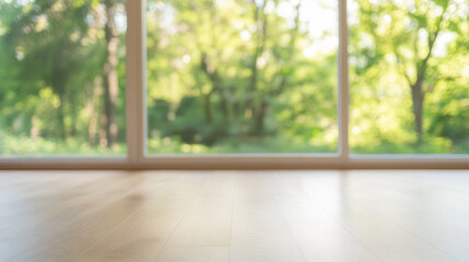 Fototapeta premium bright, blurred room with wooden floor and large windows showcasing lush green garden outside, creating serene and peaceful atmosphere