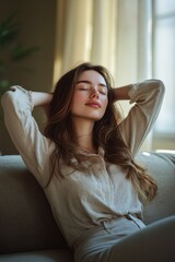 A woman relaxes indoors, soaking up the cozy ambiance with her hand on her head, evoking a sense of modern comfort and self-care.