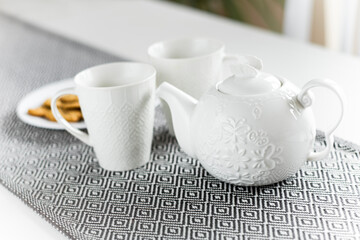 White ceramic tea set with cookies