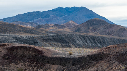 The image showcases a dramatic mountain landscape with various textures and layers, capturing the...