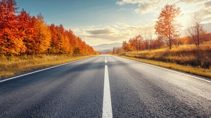 Fototapeta premium Autumnal Road Through Colorful Foliage at Sunset
