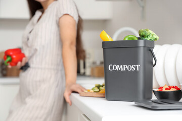 Container for compost with food on counter in kitchen, closeup