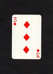A diamonds playing card isolated on a black background.
