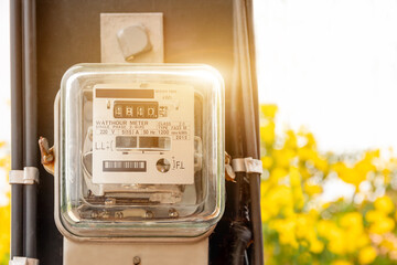 Electricity power box meters for home electrical appliances, including blurred natural green backgrounds, electric power usage concepts