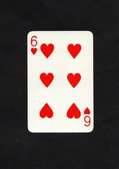 A hearts playing card isolated on a black background.