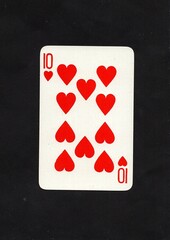 A hearts playing card isolated on a black background.