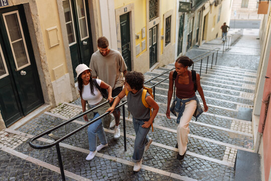Tourists walking down stairs in lisbon, portugal, exploring the city