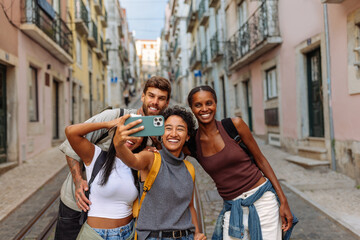 Happy tourists taking a photo of themselves in lisbon, portugal