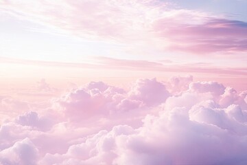 Soft pink clouds stretch across serene sky, creating tranquil at