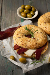 Burger with basturma, olives and rosemary