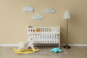 Interior of children's room with baby crib, rocking horse and lamp