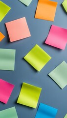 Fototapeta premium Colorful Notes Arranged in a Geometric Grid Pattern Against a Gray Background