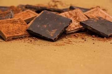 Pile of Dark Chocolate Pieces on a Sandy Surface