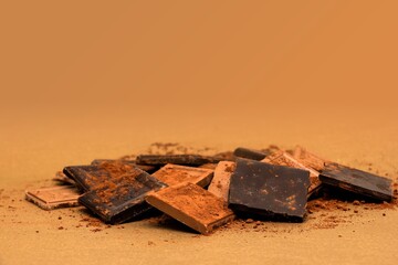 Pile of Dark Chocolate Pieces on a Sandy Surface