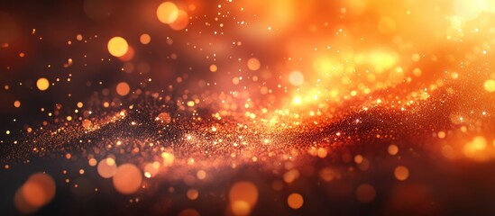 Obraz premium Warm orange and gold sparkles and glowing particles against a deep black background creating an ethereal and vibrant atmosphere of light.