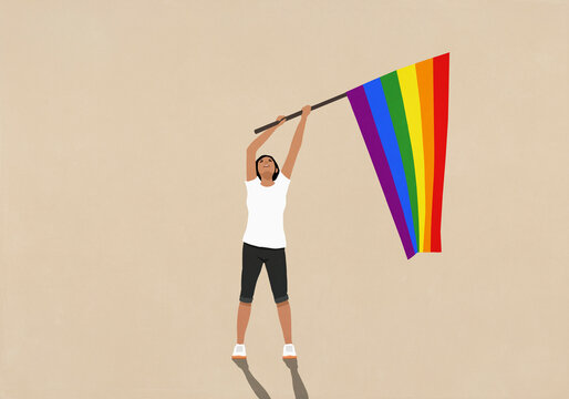 Woman waving rainbow pride flag on beige background

