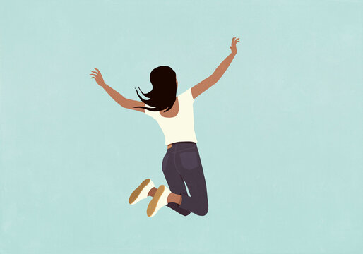 Carefree, happy woman jumping for joy on blue background
