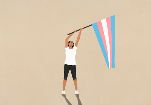 Woman waving pink, blue, and white striped Transgender Pride flag and looking up
