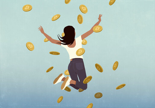 Carefree, happy woman jumping for joy among falling Bitcoins
