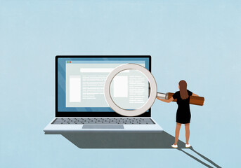 Businesswoman with large magnifying glass reading magnified text on laptop screen

