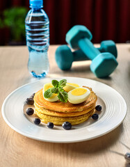 Protein-Rich Oat Pancakes with Boiled Eggs and Blueberries for a Healthy Post-Workout Meal