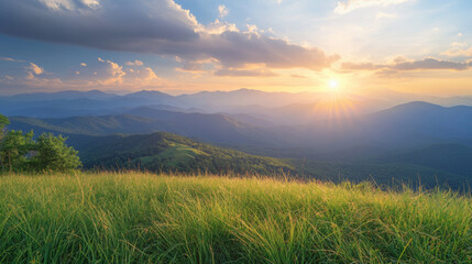 Obraz premium Scenic sunset over the Blue Ridge Mountains with rolling hills, lush greenery, and golden sunlight casting a warm glow across the landscape