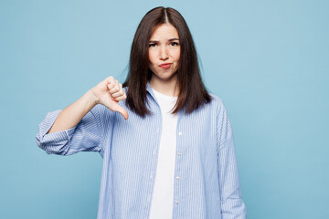Young sad dissatisfied upset Caucasian woman she wears shirt casual clothes showing thumb down...